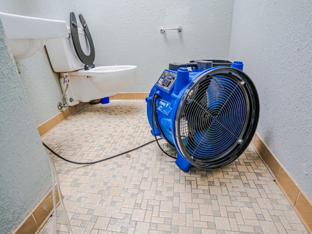 Bathroom mold remediation in progress. A drying fan is used to alleviate the smell of mold reducing chemicals.